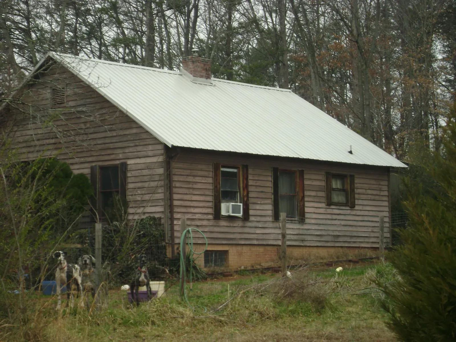 White metal roof on an old wood sided farmhouse, from a Asphalt Shingle Roof Repair job in Trumbauersville